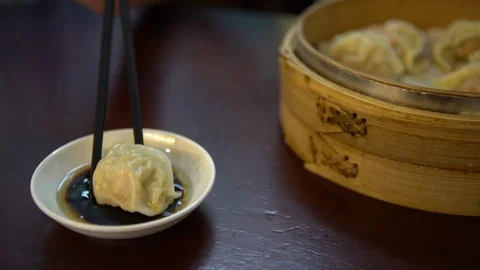 4K Dipping dumpling into soy sauce in restaurant. Traditional chinese food-Dan Stock Footage 86093058