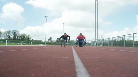 4K Disabled wheelchair athletes training together at race track Stock Footage 64599985