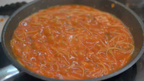 4K dish of pasta cooked to tradition with fresh Italian tomato, tuna, close-up Stock Footage 135312356