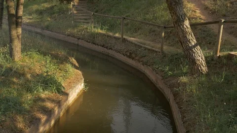 4K Ditch stream river water dirty acequia irrigation canal flowing 2 Stock Footage 113423039