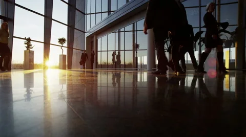 4K Diverse business group walking through busy modern office building at sunset Stock Footage