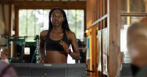 4K Diverse group of people exercising in gym, focus on girl running on treadmill Stock Footage 94919429