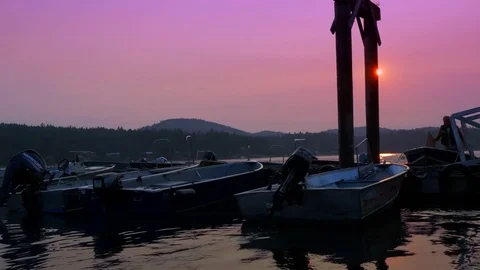 4K Docked Small Boats on Pier, Orange Sunset and Pink Sky at Dawn or Dusk, Ocean Stock Footage 78937751