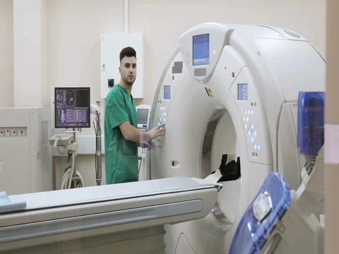 4K Doctor presses settings button of CT MRI scanner. Stock Footage 73094556