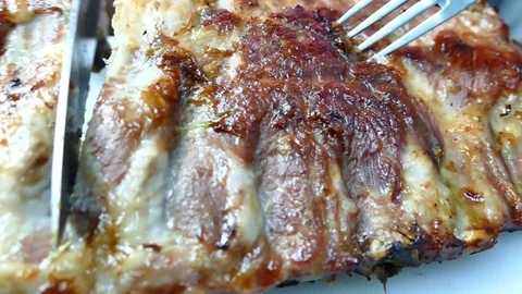 4K Dolly, close up slicing BBQ pork ribs Видео 83527162