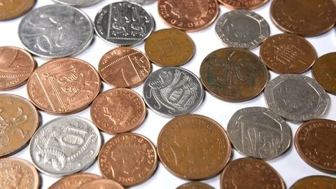 4k Dolly over metal copper and silver coin laying flat on white background  Stock Footage 90153228