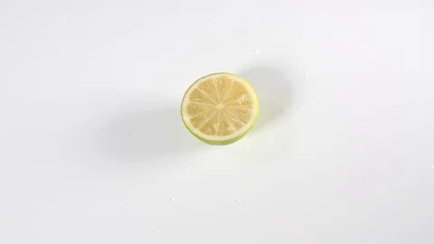 4k Dolly over top water droplets falling onto lime sliced in half Stock Footage 90166951