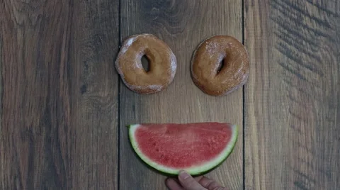 4k Donuts Composition on a Wooden Background with Watermelon Face Stock Footage 65260236