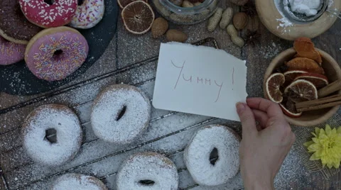 4k Donuts Composition on a Wooden Background with a Hand putting Coffee Stock Footage 65261235