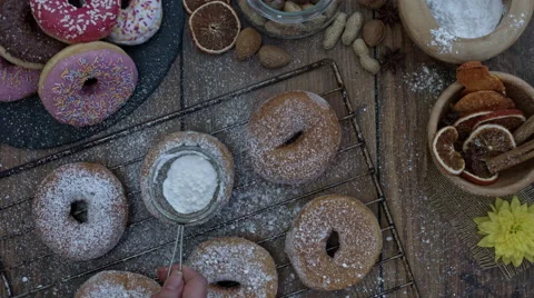 4k Donuts Composition on a Wooden Background with Sugar Powder Stock Footage 65303157