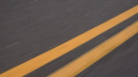 4K Double Yellow Lines Close Up Low Angle Fast Speed Blur Driving Asphalt Road Stock Footage