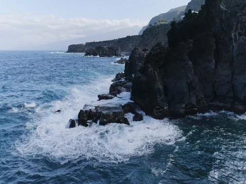 4k dramatic drone shot of oceanic powerful waves hitting rocks Stock Footage 83870921