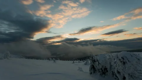 4K Dramatic sunset with low clouds and frozen landscape Stock Footage 255607333