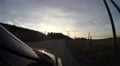 4K driving car in the evening on a small road next to a highway 4k or 4k+ Resolution