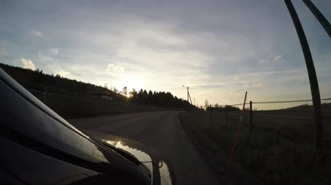 4K driving car in the evening on a small road next to a highway Stock Footage 47276564