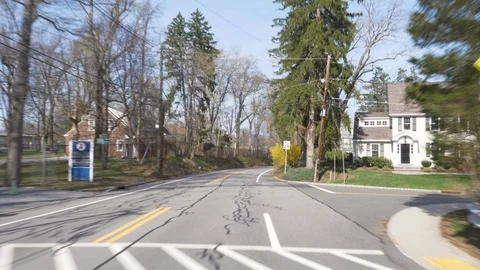 4K: Driving down a city road by a college campus in Morristown New Jersey Stock Footage 128411458