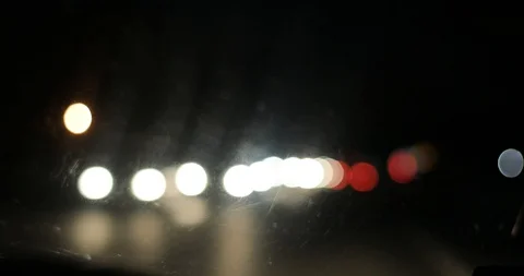 4k Driving at night road from inside car defocused traffic lights  from window  Stock Footage 87025920