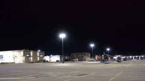 4K Driving Past Nearly Empty Parking Lot At Night Stock Footage 89196738