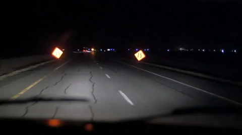 4k Driving traveling down dark highway at night with construction signs Stock Footage 57333898
