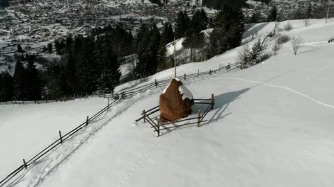 4k drone around flight above alone snow covered haystack- winter in mountains Stock Footage 221331895