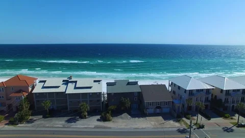 4K Drone Backing Up From Ocean Over Small Town Stock Footage 109229726