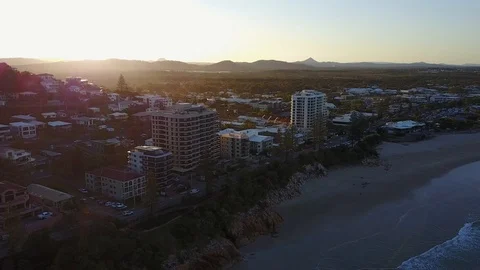 4k Drone Beach Side Town at Sunset with Mountain Backdrop Stock Footage 124298141