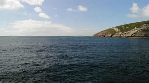 4K drone bottlenose dolphin breaching off the Welsh coast, North Wales Stock Footage 186470544