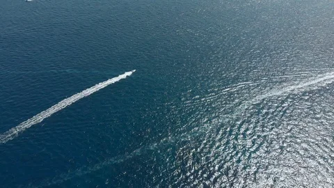 4k drone clip of a speedboat riding into the setting sun in the Mediterranean. Stock Footage