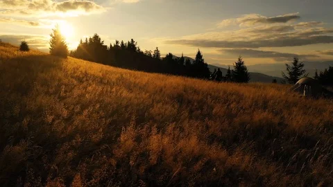 4k drone clip with two mountain bikes and a tent on a mountain meadow at sunrise Video stock 118082017