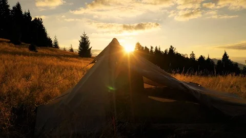 4k drone clip with two mountain bikes and a tent on a mountain meadow at sunrise 스톡 동영상 118082989