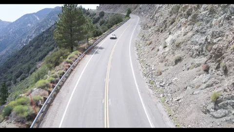 4k Drone Convertible Car driving in mountains Stock Footage 249282928