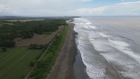 4k drone costa rica deserted beach dark sand waves ocean trees landscape Stock Footage