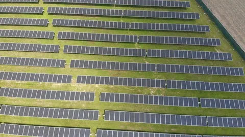 4K Drone Descends Over Solar Panel Field Stock Footage 129776024