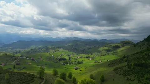 4K drone descent over mountain village – scattered houses in alpine landscape Stock Footage 343852966