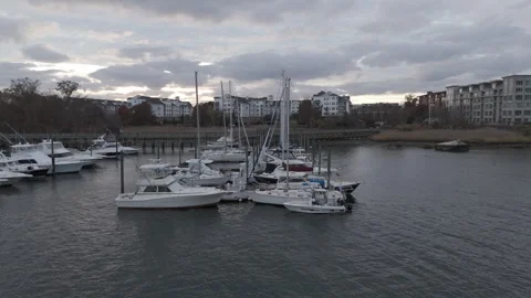 4k drone flies toward and then rises above docked boats to reveal horizon Stock Footage 291228009