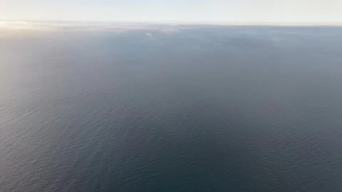 4K Drone Flight above Misty Blue Sea, Soft Sunset Afterglow and Calm Water Stock Footage 334328010