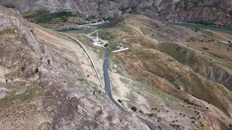 4K Drone Flight Along Mountainside Toward Historic Church and Bridges Vídeos de archivo 336257772