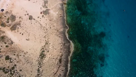 4K drone flight over the coastline with crystal clear waters and rocks Stock Footage 236792344