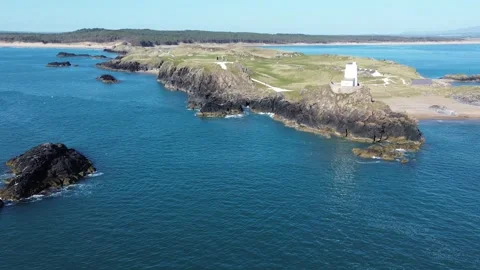 4K Drone Flight Over the North Wales Coast with Lighthouse, Forest and Boat Near Vídeo Stock 334686662