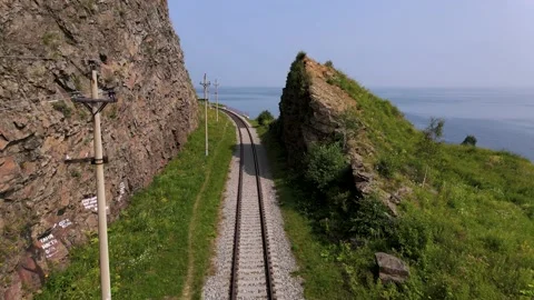 4K Drone flight over the railway between the rocks on the shore of Lake Baikal. Stock Footage 159526324