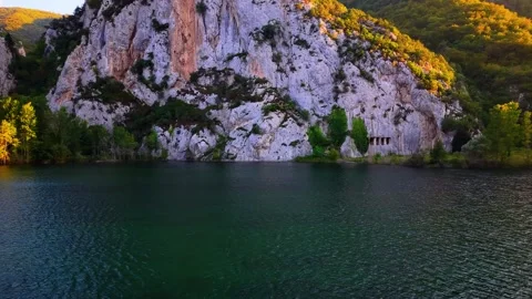 4K Drone Flight Over River at Sunset with Ancient Royal Tombs Stock Footage 336544809