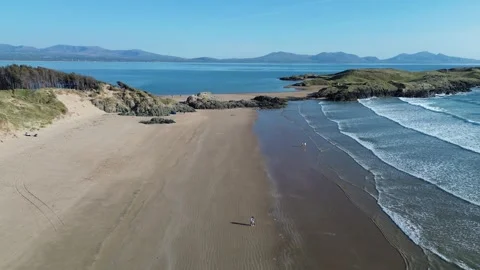 4K Drone Flight Over Sunny Beach in Wales with Sea and Pine Forest Видео 334030445