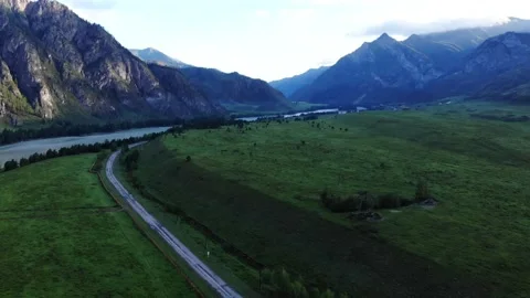 4k Drone flight at sunrise - Mountains and road Stock Footage 202106984