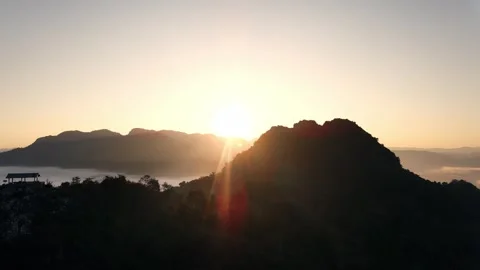4k drone flight through passing through the mountains with sunset Stock Footage 344315944