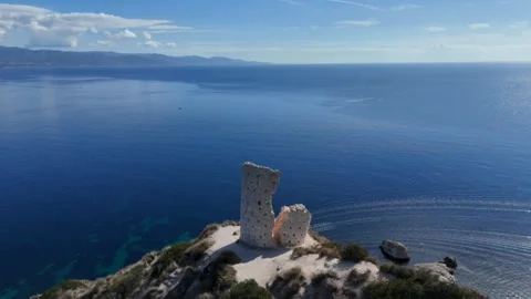 4K Drone flight towards Torre del Poetto ruin with Turquoise sea background Vídeos de archivo 328048755