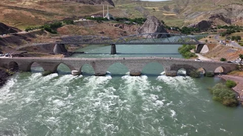 4K Drone Flight Upstream Toward Historic Stone and Railway Bridges Stock Footage 336237905