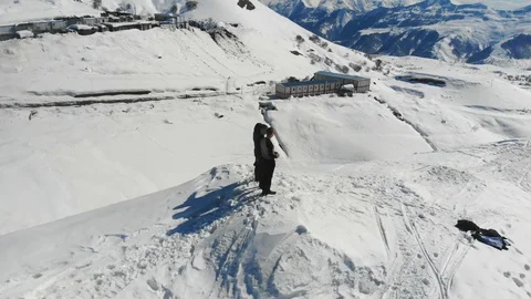 4k drone fly over 3 guys standing on the slope in winter Stock Footage 112128839