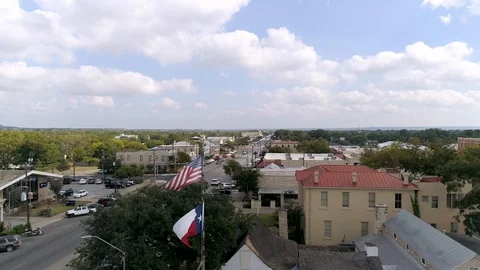 4K Drone Fly By Texas Flag Fredericksburg Texas Main Street Stock Footage 118399136