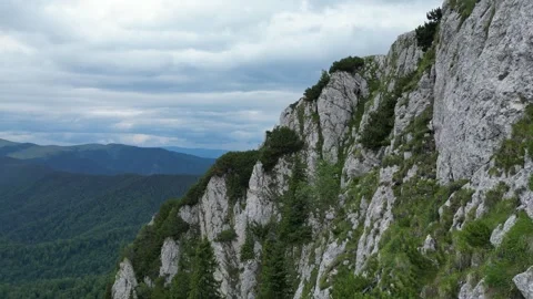 4K drone flyby along mountain cliff – dramatic rocky landscape Stock Footage 344551563
