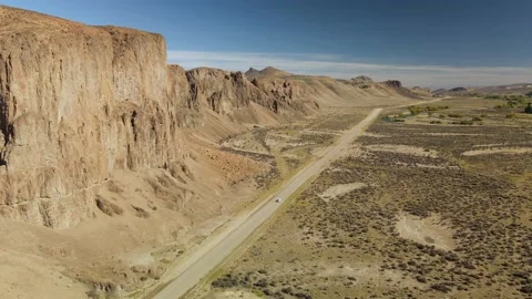 4K drone flying above a car traveling through the desert. Stock Footage 154622941